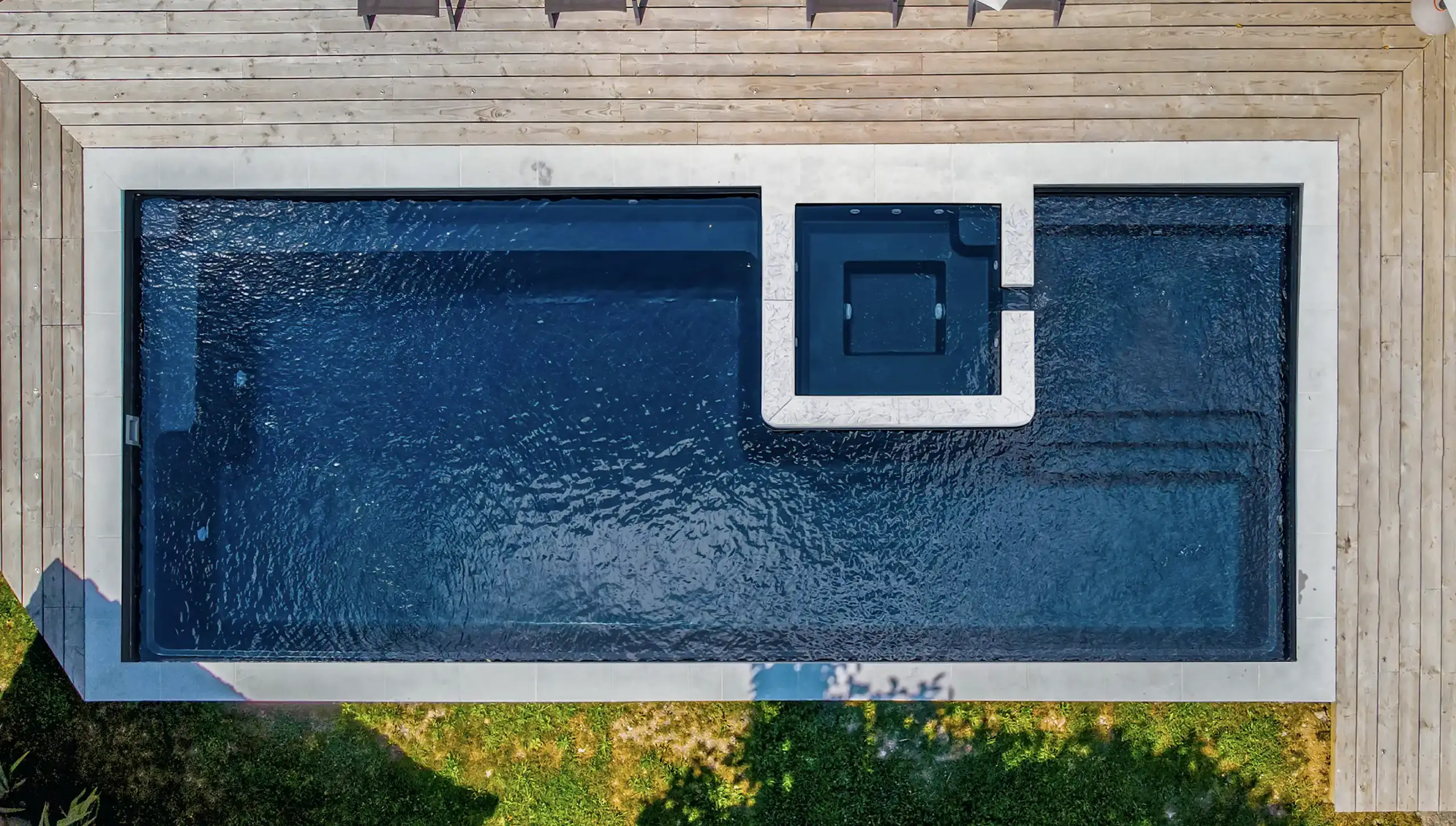 Sacred fiberglass pool — integrated spa with tanning ledge and swim lane