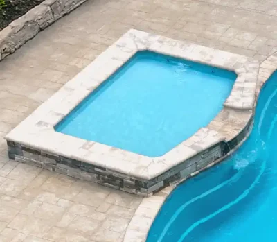 Shoreline tanning ledge — contouring ledge with curved wall alongside pool